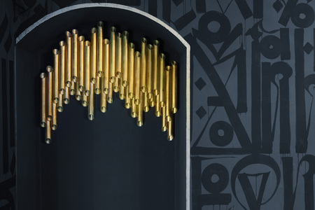Golden tube on gray wall. Backgorund.Details of interior.の写真素材