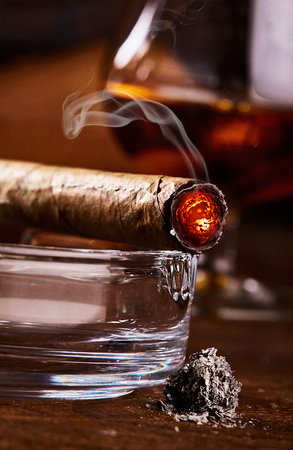 close view on burning smoking cuban cigar with ashの写真素材