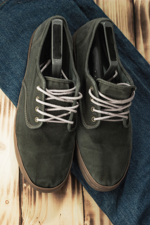 FAshion dark green sneakers and jeans clsoeup.の写真素材