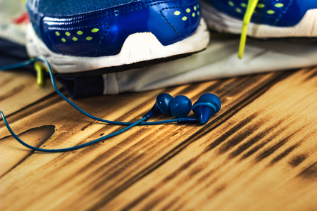 sneakers and earphones on the old wooden textures.の写真素材