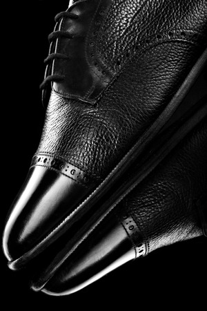 Black oxford polished shoes on black miror background.Shoes shine. Close up.の写真素材