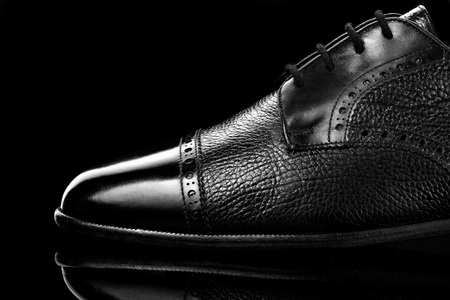 Black oxford polished shoes on black miror background.Shoes shine. Close up.の写真素材