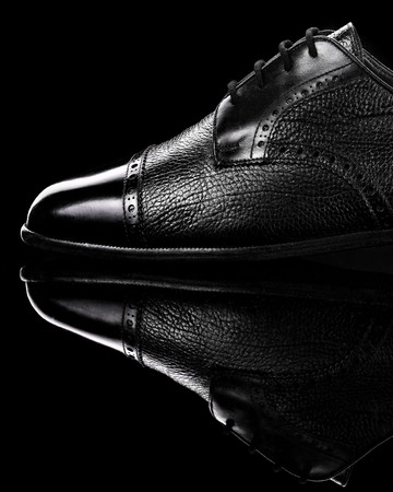 Black oxford polished shoes on black miror background.Shoes shine. Close up.の写真素材
