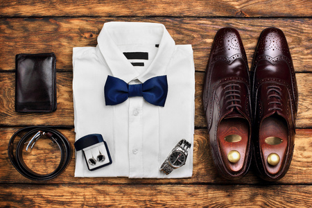 Dark brown brogues, white shirt and men's accessroies cufflinks, watch, leather belt, leather potmone wallet . Men's look .Set of gentlemen.の写真素材