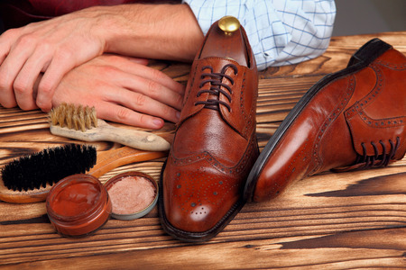 Brogues shoes brushes, cream and shoes master hands.Selective focusの写真素材