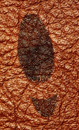 Handmade shoes symbol. Manufactured shoes concept.Silhouette of shoes track from fingerprint.On brown leatherの写真素材