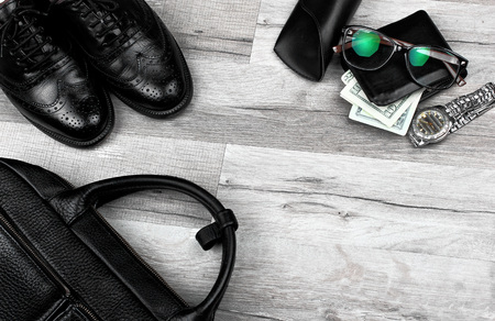 Briefcase, brogues , shoes,wallet with money and watch.Man accessories in business style. On gray woden background, fashion industry, top view.Copy spaceの写真素材