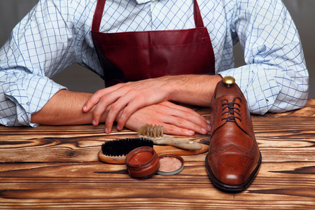 shoes master hands ,brogues,shoes brushes, cream.Selective focusの写真素材