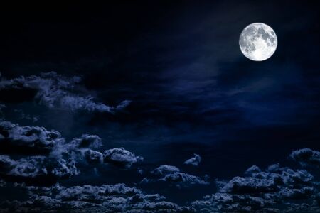 background night sky with stars, moon and cloudsの写真素材