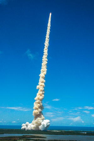 Shooting like a roman candle into Florida's blue sky, Space Shuttle Discovery kicks off the Fourth of July fireworks with its own fiery display and makes history with the first ever launch on Independence Day. This image furnished by NASAのeditorial素材