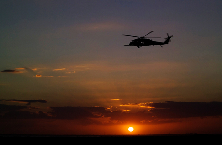 A helicopter patrols the sky over NASA's Kennedy Space Center in Florida before the launch of space shuttle Discovery on the STS-119 mission. This image furnished by NASAのeditorial素材