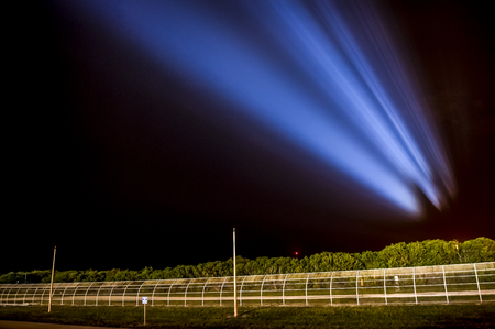 The space shuttle Endeavour is seen projected in the sky as powerful xenon lights illuminate launch pad 39a shortly. This image furnished by NASAのeditorial素材