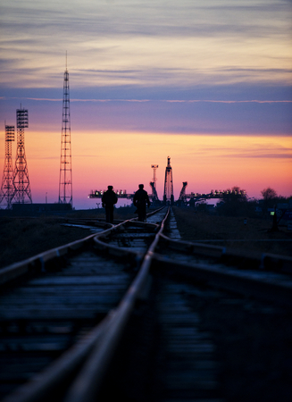 Russian security officers walk along the railroad tracks out to the launch pad Monday, Nov. 11, 2011 at the Baikonur Cosmodrome in Kazakhstan. This image furnished by NASAのeditorial素材