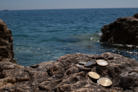 Euro coins with sea view on back  の写真素材
