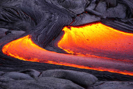 Hot magma of an active lava flow over old lava field, the lava cools slowly and solidifies, Kilauea, Big Island, Hawaiiの写真素材