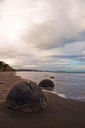 The Moeraki Boulders are unique large round stones lying along of Koekohe Beach in New Zealandの写真素材
