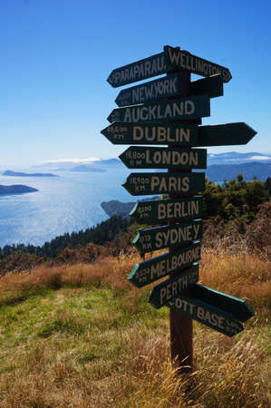Wooden signpost in Queen Charlotte Track showing distance to international cities around the World, New Zealandの写真素材
