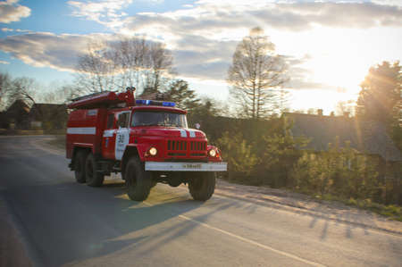 17.05.17. Russia, Strugi Krasnye, Red fire truck rushes to extinguish the fire. fire truck rides...