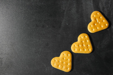 Heart cookies on a dark background. Love cookies. Heart in baking.の写真素材