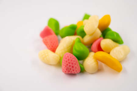 Close-up of a pile of a colorful jelly candies in the form of fruit on an isolated white background.の写真素材