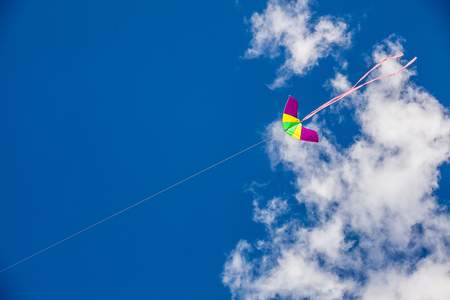 kite flying on sky background with clouds