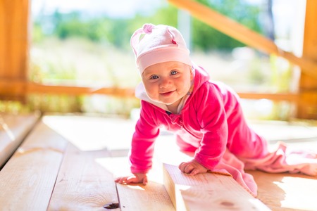 baby summer Romper in pink on the wooden deckの写真素材