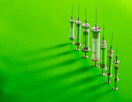 veterinary syringes on a green backgroundの写真素材