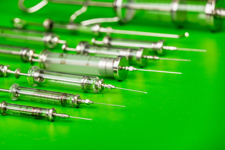 veterinary syringes on a green backgroundの写真素材