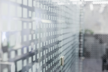 glass wall in office with modern pattern blurred backgroundの写真素材