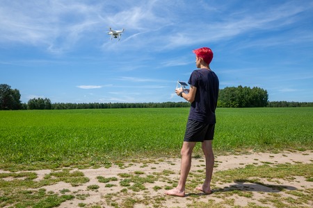 the guy with the red hair is flying a drone