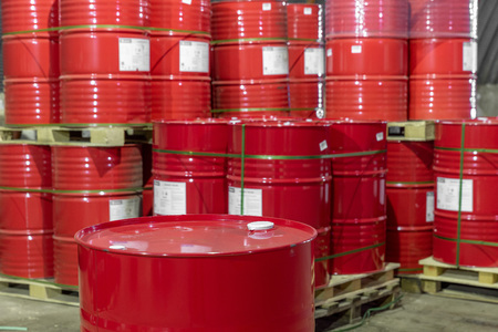 a stack of red barrels on pallets in a warehouseの写真素材