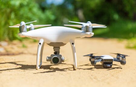 two drones on the ground-big and small