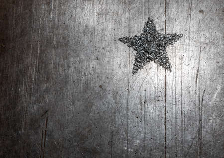 One star made of metal shavings on a metal textured sheet.の写真素材