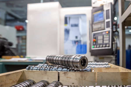 the steel part is large against the background of the cnc machine. Low-depth-of-field photography