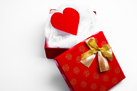 Open red box with valentine heart on white backgroundの写真素材
