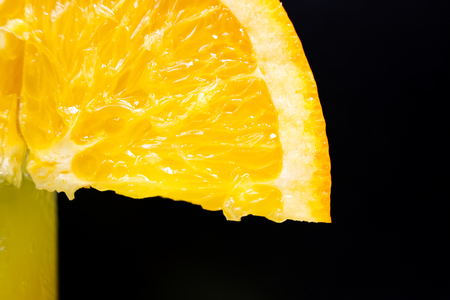 Slice of juicy orange ripe vitamins orange  close-up, on the black backgroundの写真素材