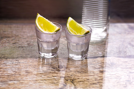 Russian vodka with lemon on the tableの写真素材