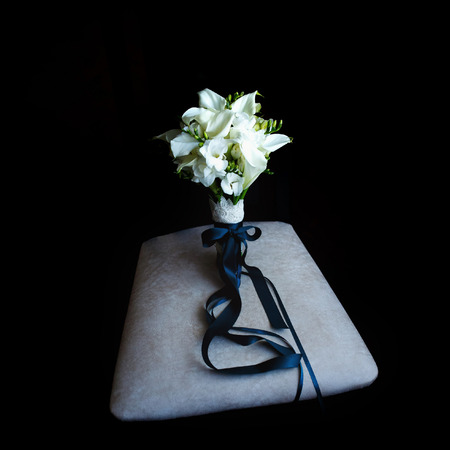 Bride's bouquet staying on the gray pillowの写真素材