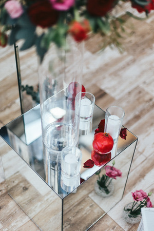 Pomegranate and white candles on the glass boxの写真素材