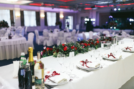 Wedding table lusury set and decorated with red roses and greeneryの写真素材