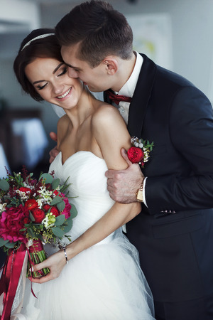 Fiance holds bride by the shoulders and she smilesの写真素材