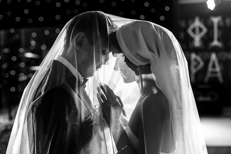 Just married dance being covered with a veilの写真素材