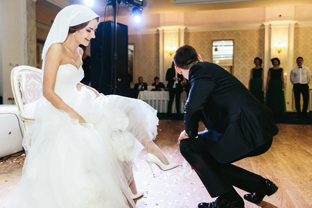 Fiance staying on kneels before a brideの写真素材