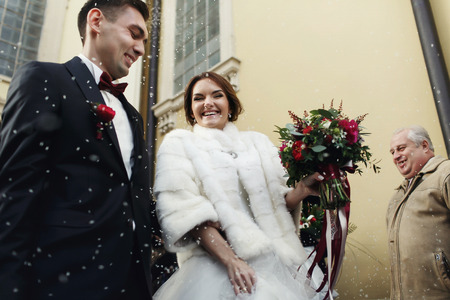 Newlyweds pictured from below in the rain of riceの写真素材