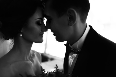 Bride and fiance touch each other nosesの写真素材
