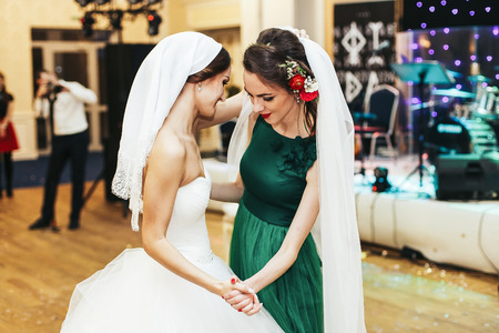 Bridesmaid dance in the bride's veilの写真素材