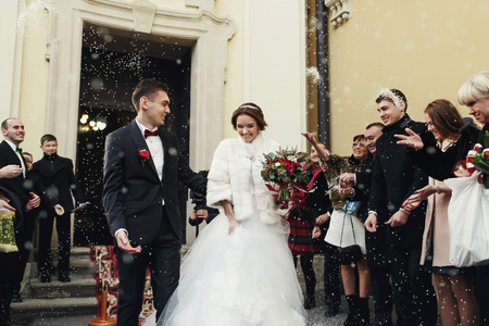 Just married walk among the guests in the rain of riceの写真素材
