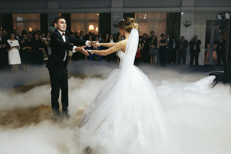 Newlyweds whirl in the smokeの写真素材