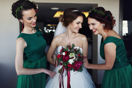 Bridesmaids making fun with brideの写真素材