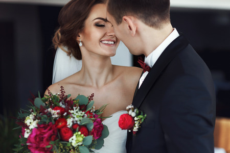 Bride smiles while looking at fiance before a kissの写真素材